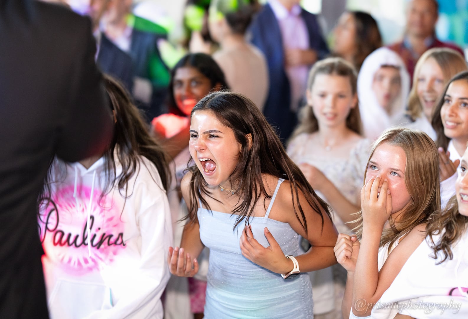 A child screams in excitement at a bat mitzvah