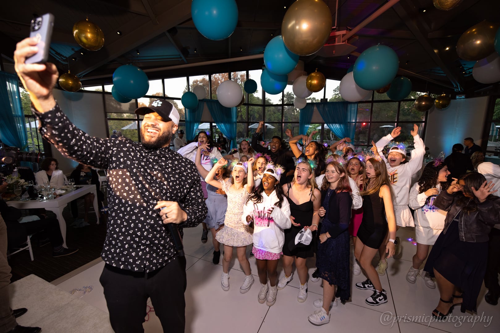 Children pose with a DJ at a bat mitzvah