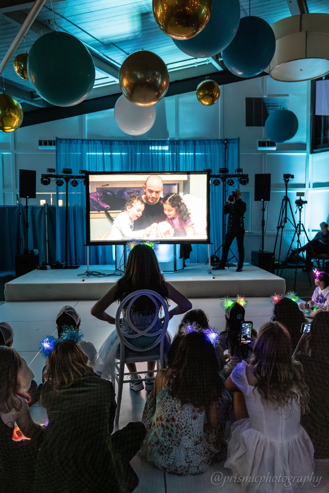 A child watches a childhood movie at a bat mitzvah