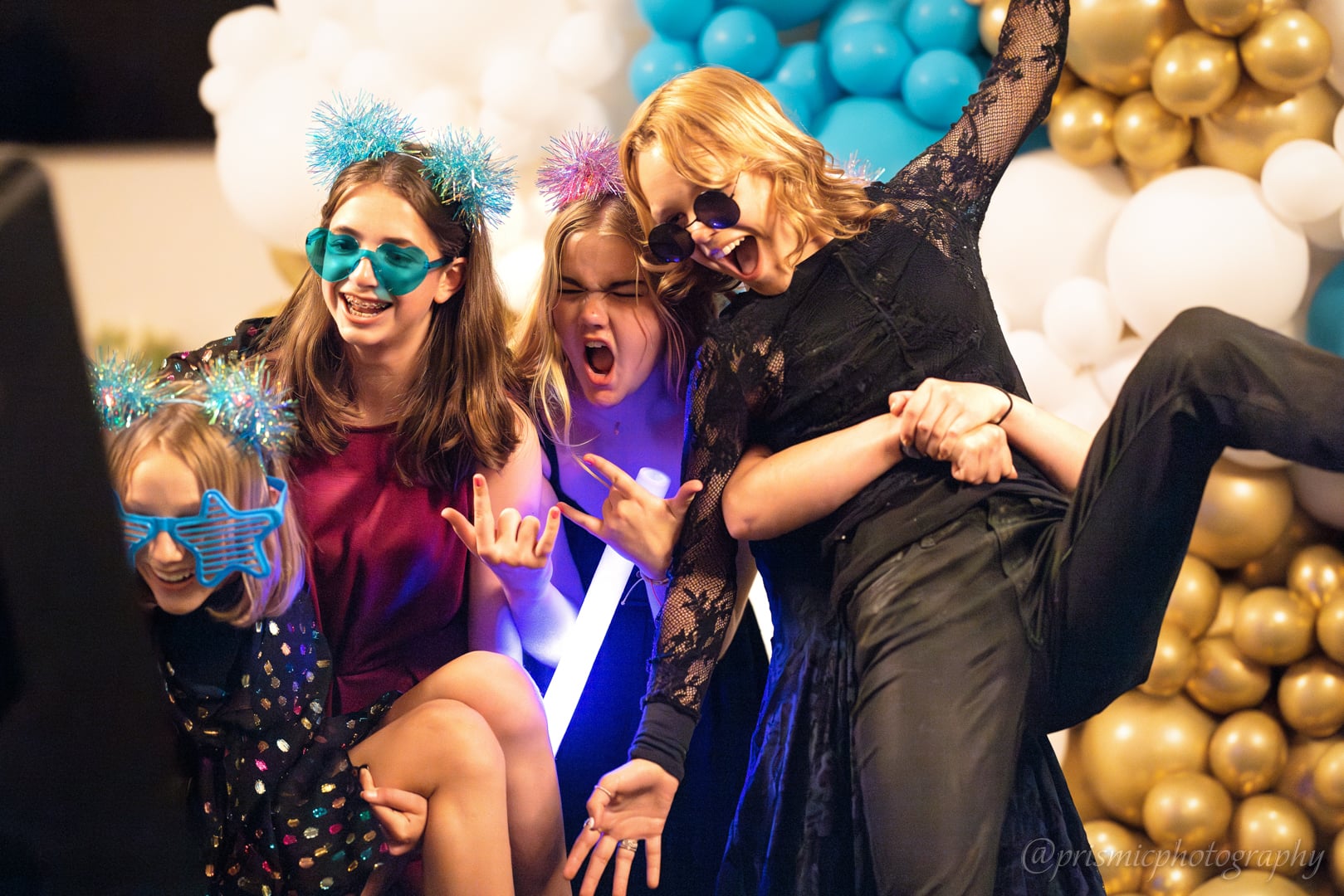 Girls pose for a camera at a bat mitzvah