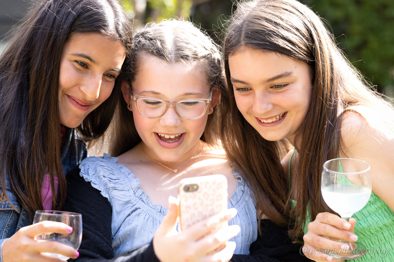 Children look at a phone at a bat mitzvah