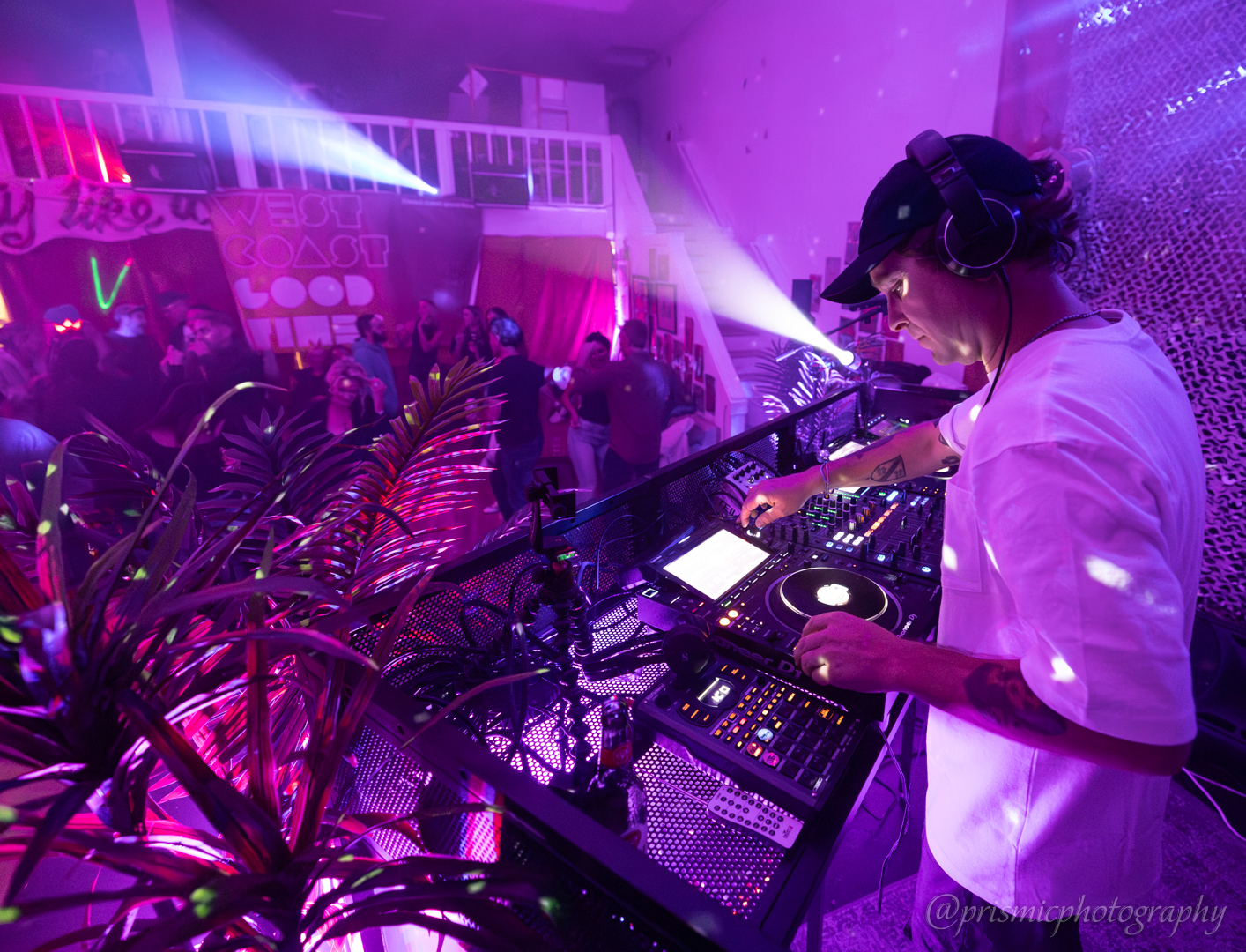 A DJ operates tables for a crowd
