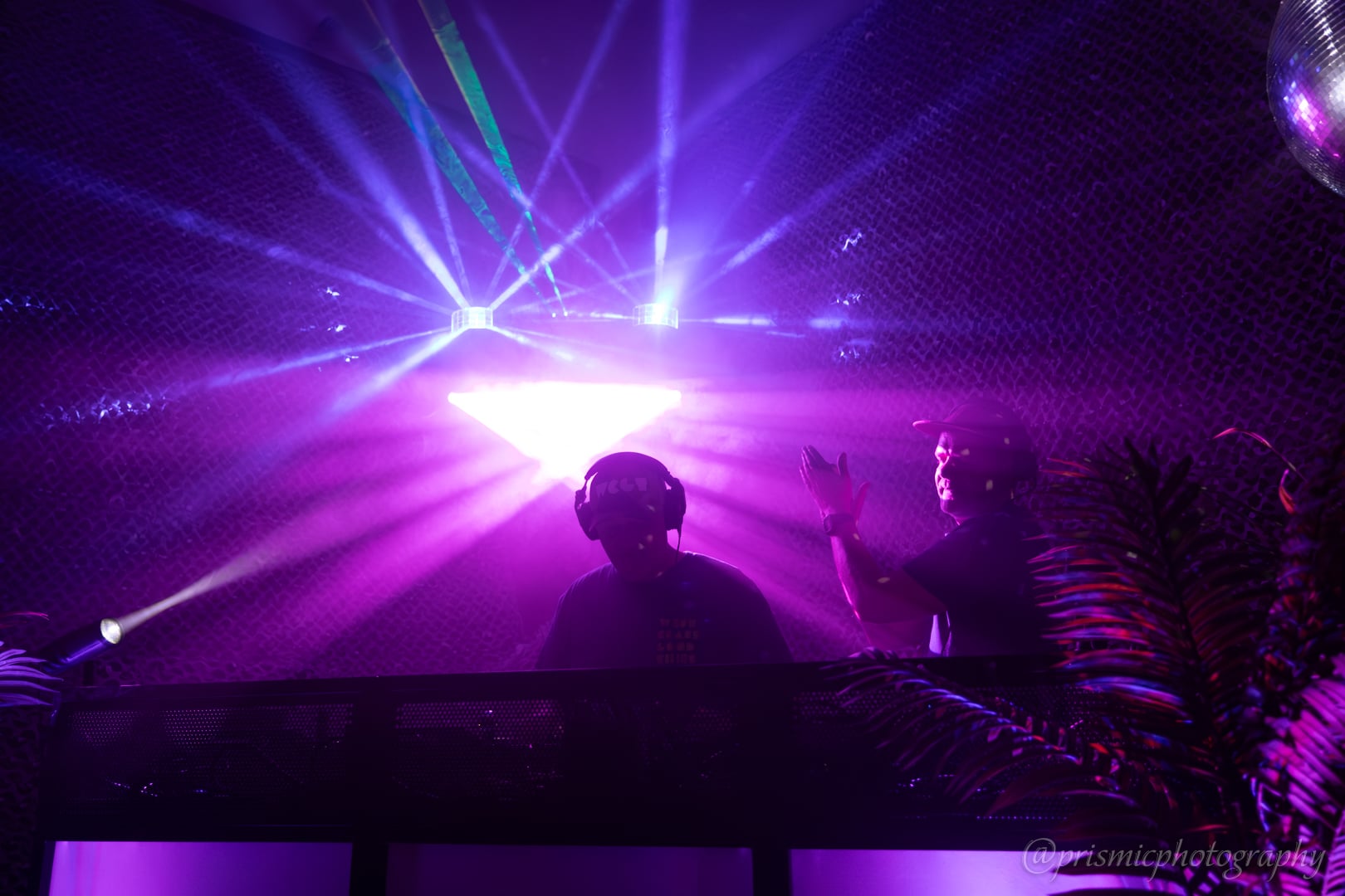 A pair of DJs with stage lights