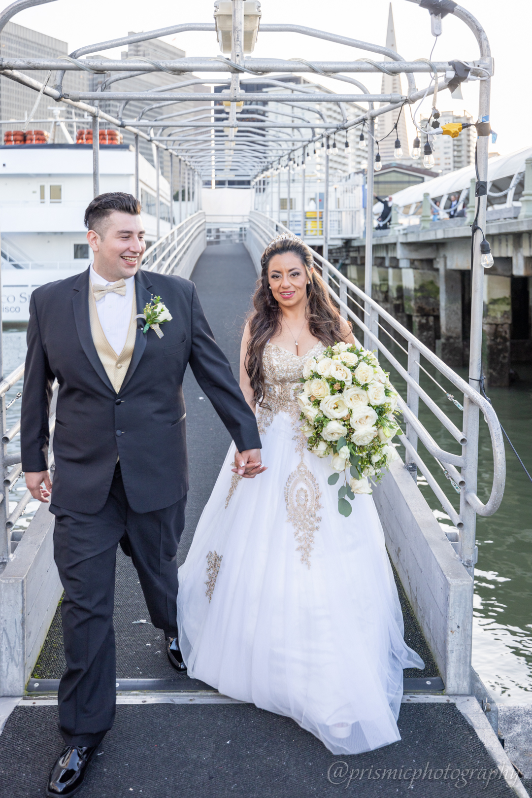 A bride and groom on a ramp about to board the Hornblower boat